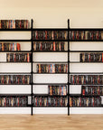 DVD media storage shelving extension with black shelves and black vertical post, three bays, 31-inch shelf width, shown with open media storage shelf levels.