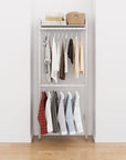 Closet storage system with satin shelves and satin vertical posts, plus hanger bars, shown with open shelving and one open shelf level.