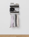 Closet storage system with satin shelves and satin vertical posts, plus hanger bars, shown with open shelving.