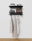 Closet storage system with black shelves and black vertical posts, plus hanger bars, shown with open shelving.