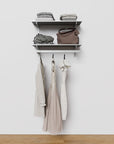 Closet storage system with satin shelves and satin vertical posts, plus hanger bars, shown with open shelving.
