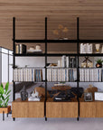 Floor-to-ceiling room divider shelving unit with lower storage cabinets with black shelves and black vertical posts, 3 bays, 31-inch bay width, six open shelf levels, floor-to-ceiling supports, styled in a room setting with books and decor.