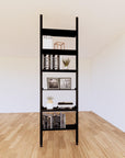 Floor-to-ceiling room divider shelving extension with lower storage cabinet with black shelves and black vertical post, one bay, 24-inch bay width, six open shelf levels, floor-to-ceiling supports.