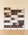 DVD media storage shelving unit with satin shelves and satin vertical posts, three bays, 24-inch shelf width, shown with open media storage shelf levels.