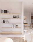Wood shelf modular shelving unit with black shelves and black vertical posts, one bay, styled in a modern room.