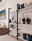 Modular shelving unit with white shelves and satin vertical posts, one bay, styled in a modern room.
