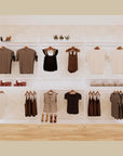 Three-bay retail display shelving unit with white shelves and white vertical posts, shown with open display shelves.