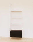 Retail display shelving extension with black shelves, white vertical post, and base cabinets in a 31-inch, one-bay configuration, shown with open display shelving.