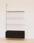 Retail display shelving unit with black shelves, satin vertical posts, and base cabinets in a 48-inch configuration, shown with open display shelving.