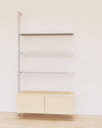 Retail display shelving unit with Casting Light shelves, satin vertical posts, and base cabinets in a 48-inch configuration, shown with open display shelving.