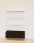 Retail display shelving unit with black shelves, white vertical posts, and base cabinets in a 48-inch configuration, shown with open display shelving.