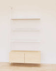 Retail display shelving unit with Casting Light shelves, white vertical posts, and base cabinets in a 48-inch configuration, shown with open display shelving.
