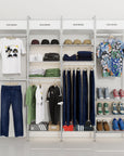 Retail display shelving unit with black shelves and black vertical posts, four bays.