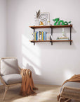Aluminaire two-shelf modular shelving unit with wood-look aluminum shelves, black vertical posts, one bay, 24-inch width, and two open shelf levels styled in a room setting.