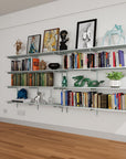 Modular shelving unit with satin shelves, satin vertical posts, and one bay, shown with three open shelf levels styled in a room setting.