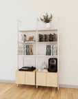 LP vinyl media storage shelving unit with white shelves and white vertical posts, with Casting Light wood cabinet storage, three bays, 24-inch shelf width, shown with open record storage shelf levels.