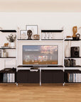 Harmony four-bay media unit with black shelves and white vertical posts, four bays, shown with open shelf levels.