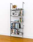 Modular shelving unit with satin shelves and satin vertical posts, one bay, 33-inch shelf width, styled in a modern room.