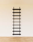 Modular media shelving unit with black shelves, black vertical posts, and one bay, shown with eight open shelf levels.