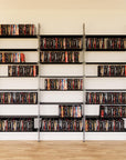 DVD media storage shelving extension with black shelves and satin vertical post, three bays, 31-inch shelf width, shown with open media storage shelf levels.