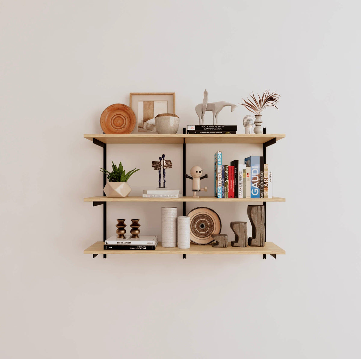 Modular shelving unit with Casting Light shelves, black vertical posts, and one bay, shown with three open shelf levels.