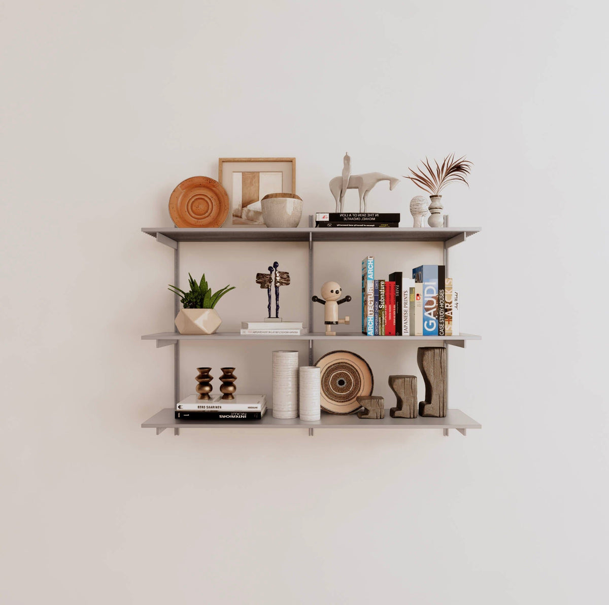 Modular shelving unit with satin shelves, satin vertical posts, and one bay, shown with three open shelf levels.
