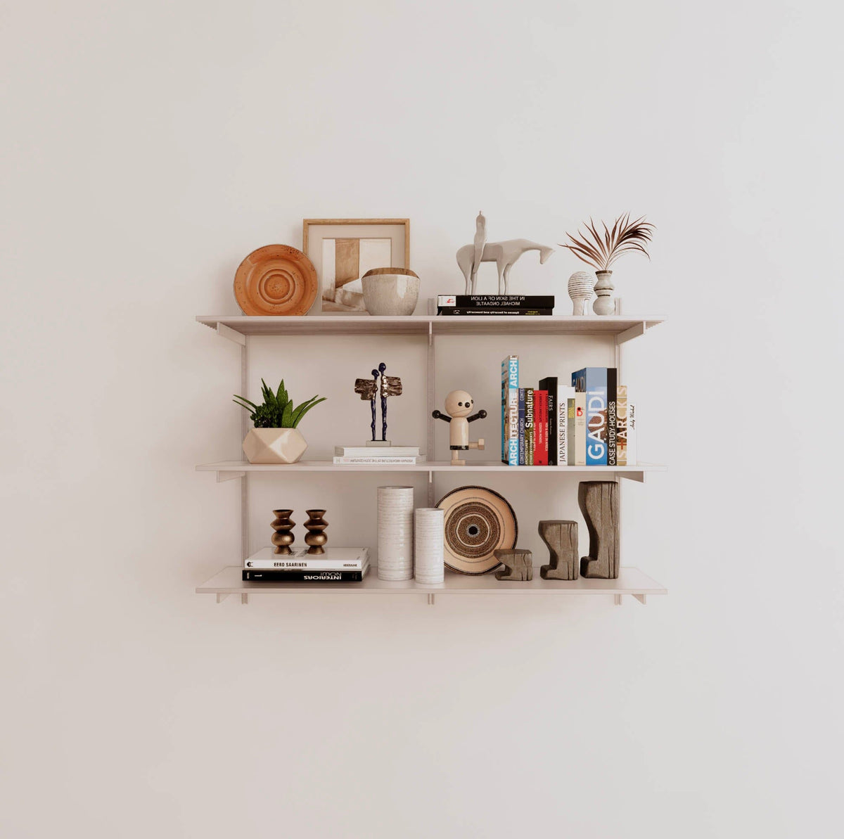 Modular shelving unit with white shelves, white vertical posts, and one bay, shown with three open shelf levels.