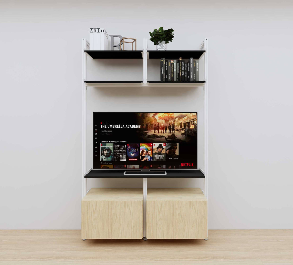Modular media shelving unit with black shelves and white vertical posts, with Casting Light wood cabinet storage, two bays, shown with open shelf levels.