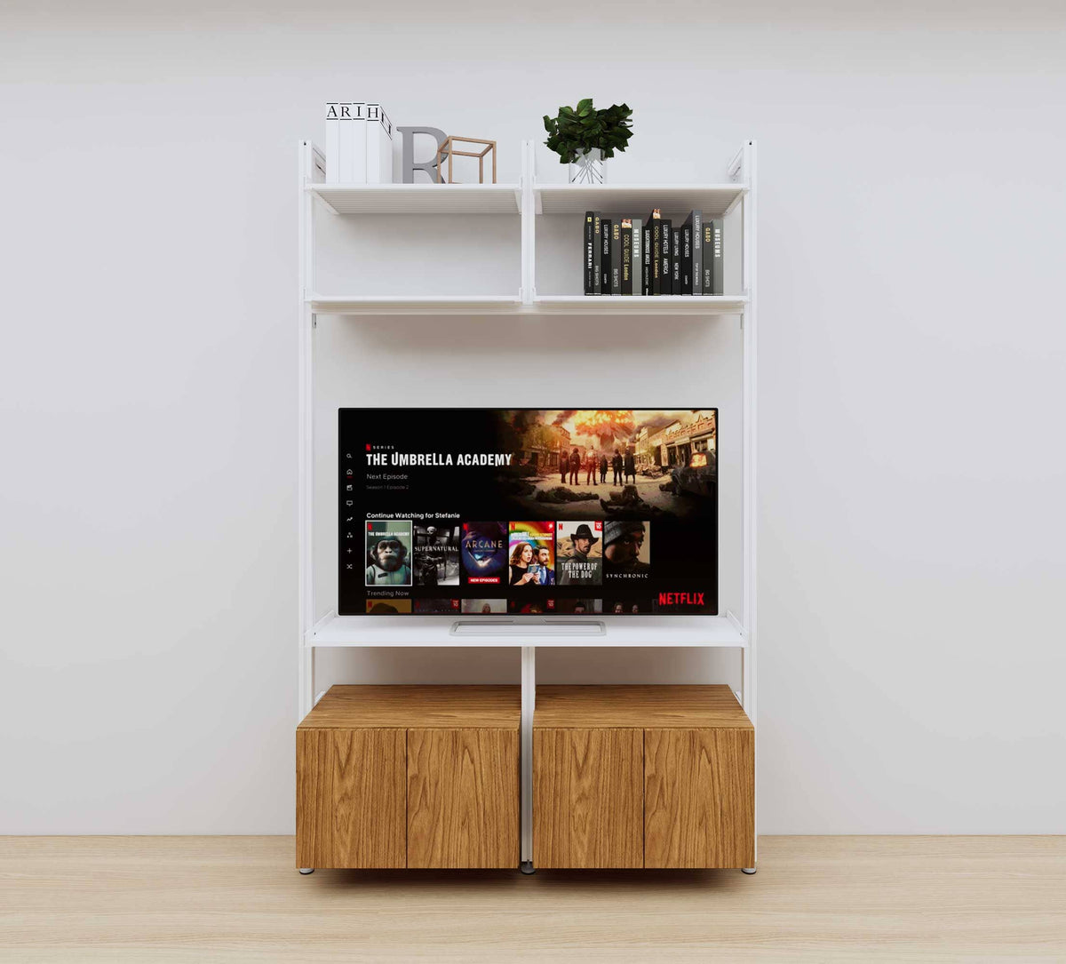 Modular media shelving unit with white shelves and white vertical posts, with Tea for Two wood cabinet storage, two bays, shown with open shelf levels.