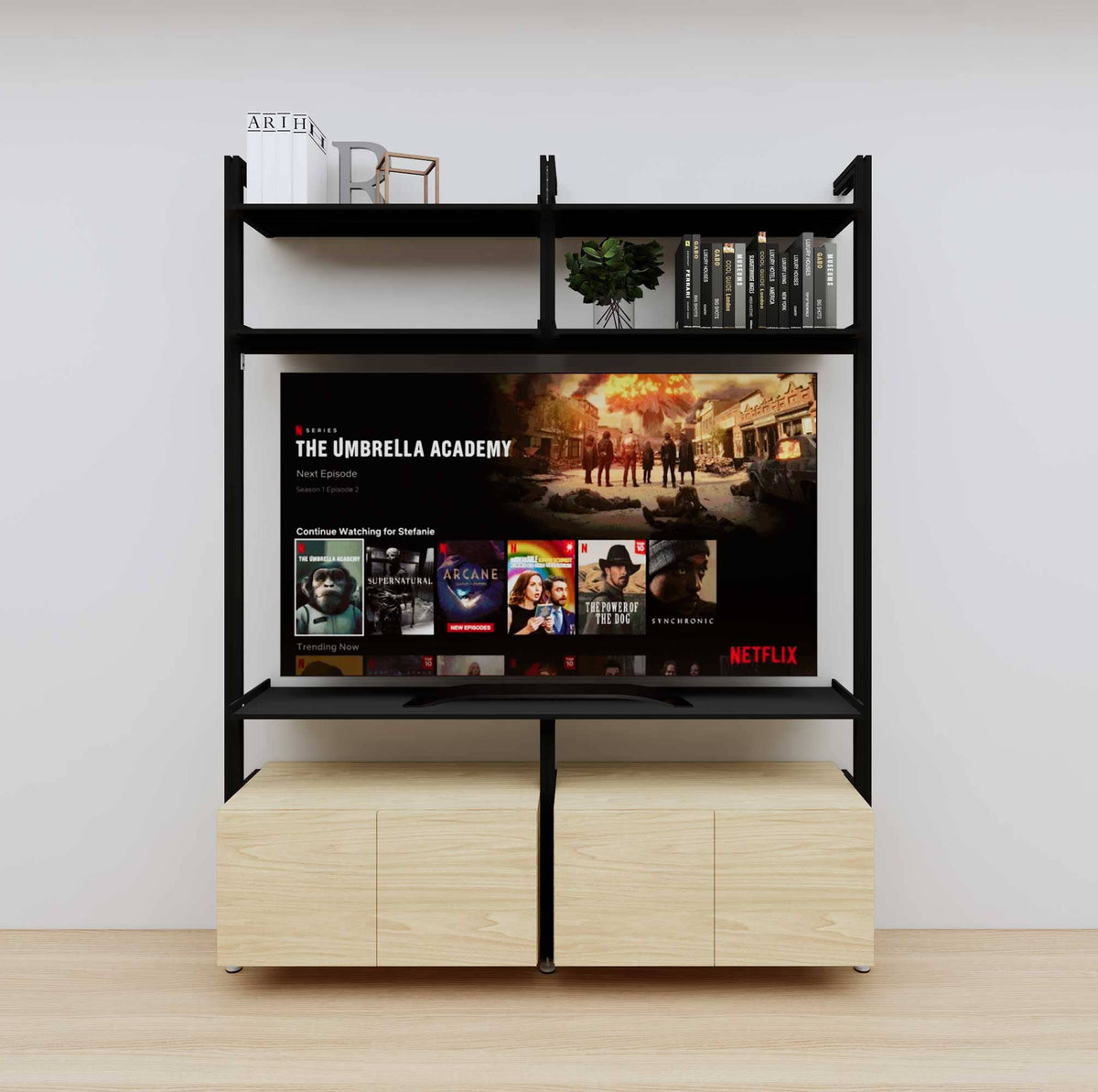 Modular media shelving unit with black shelves and black vertical posts, with Casting Light wood cabinet storage, two bays, shown with open shelf levels.