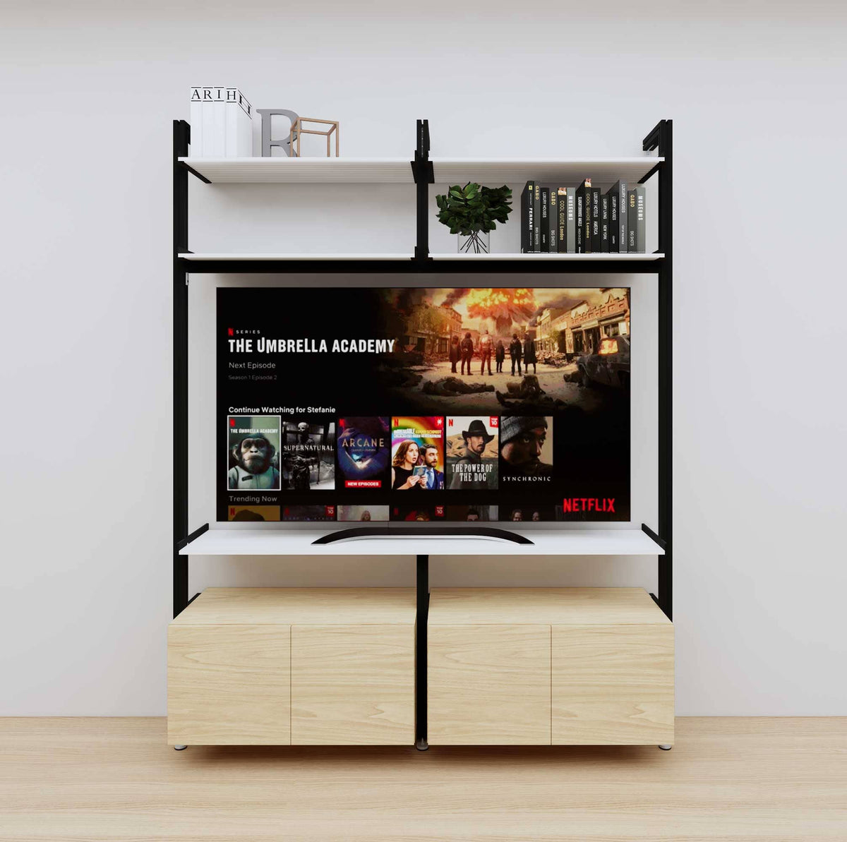 Modular media shelving unit with white shelves and black vertical posts, with Casting Light wood cabinet storage, two bays, shown with open shelf levels.