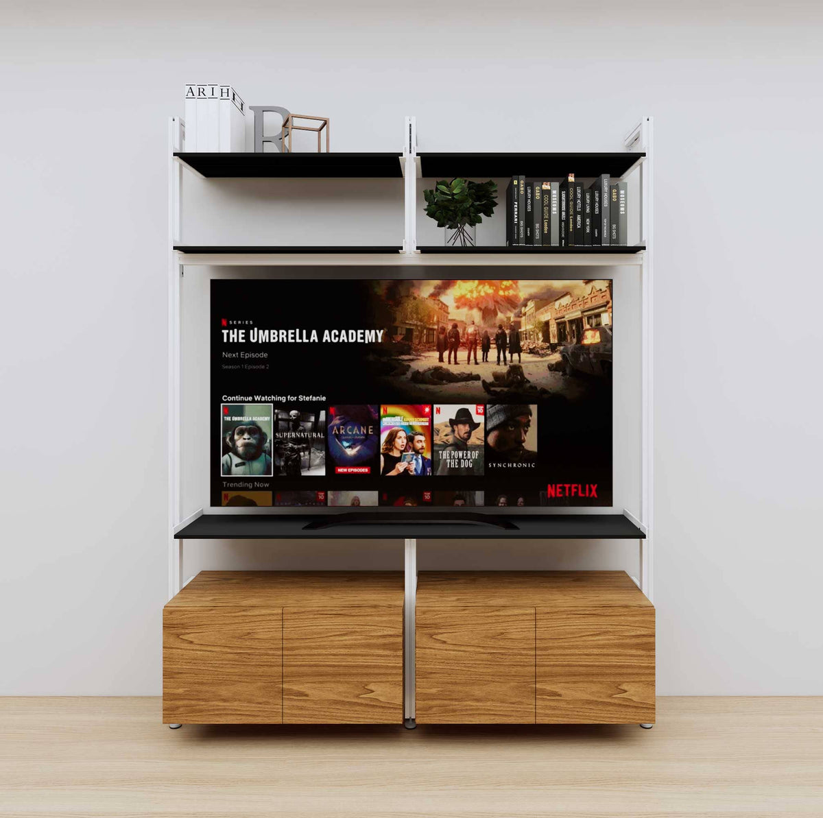 Modular media shelving unit with black shelves and white vertical posts, with Tea for Two wood cabinet storage, two bays, shown with open shelf levels.
