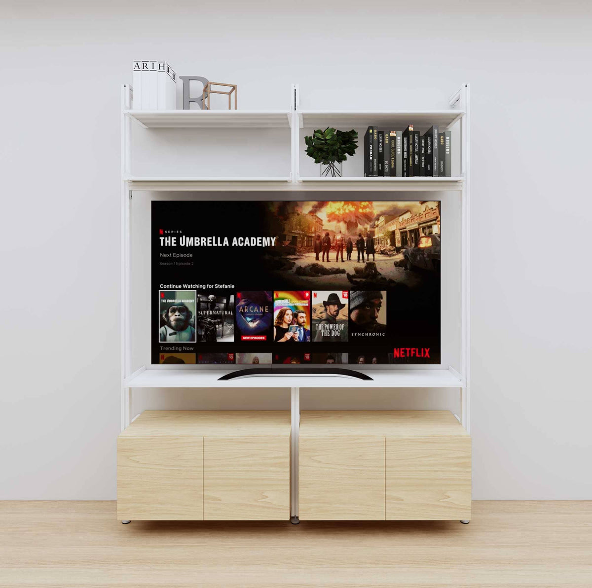 Modular media shelving unit with white shelves and white vertical posts, with Casting Light wood cabinet storage, two bays, shown with open shelf levels.