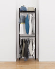 Closet storage system with black shelves and black vertical posts, plus hanger bars, shown with open shelving and one open shelf level.