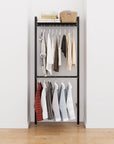 Closet storage system with black shelves and black vertical posts, plus hanger bars, shown with open shelving and one open shelf level.