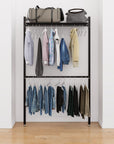 Closet storage system with black shelves and black vertical posts, plus hanger bars, shown with open shelving and one open shelf level.