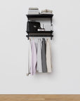 Modular shelving unit with storage with wood shelves and black vertical posts.