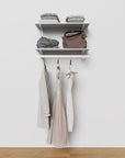 Closet storage system with white shelves and white vertical posts, plus hanger bars, shown with open shelving.