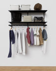 Modular shelving unit with storage with black shelves and black vertical posts.