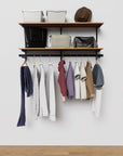 Modular shelving unit with storage with wood shelves and black vertical posts.