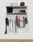 Modular shelving unit with storage with white shelves and white vertical posts.