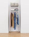 Closet storage system with satin shelves and satin vertical posts, plus hanger bars, shown with open shelving.