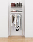 Closet storage system with satin shelves and satin vertical posts, plus hanger bars, shown with open shelving.