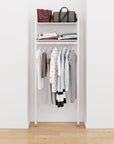 Closet storage system with white shelves and white vertical posts, plus hanger bars, shown with open shelving.