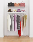 Closet storage system with white shelves and white vertical posts, plus hanger bars, shown with open shelving.
