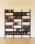 DVD media storage shelving unit with black shelves and black vertical posts, three bays, 24-inch shelf width, shown with open media storage shelf levels.