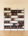 DVD media storage shelving unit with black shelves and satin vertical posts, three bays, 24-inch shelf width, shown with open media storage shelf levels.