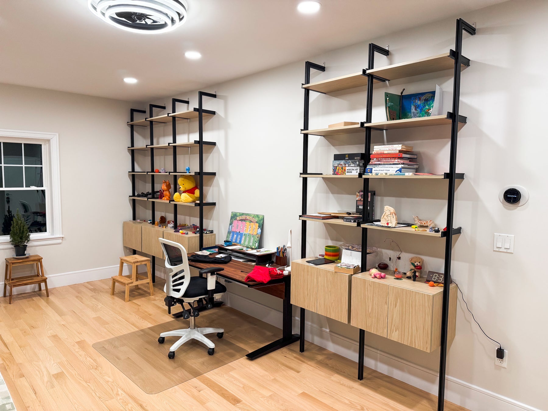 Home office with a desk, chair, and bookshelves.
