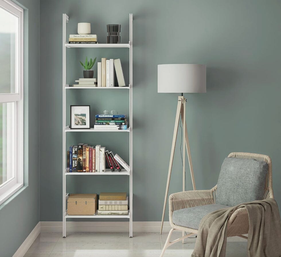 Modular shelving unit with black shelves and satin vertical posts, one bay, styled in a modern room.