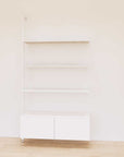 Retail display shelving unit with white shelves, white vertical posts, and base cabinets in a 48-inch configuration, shown with open display shelving.